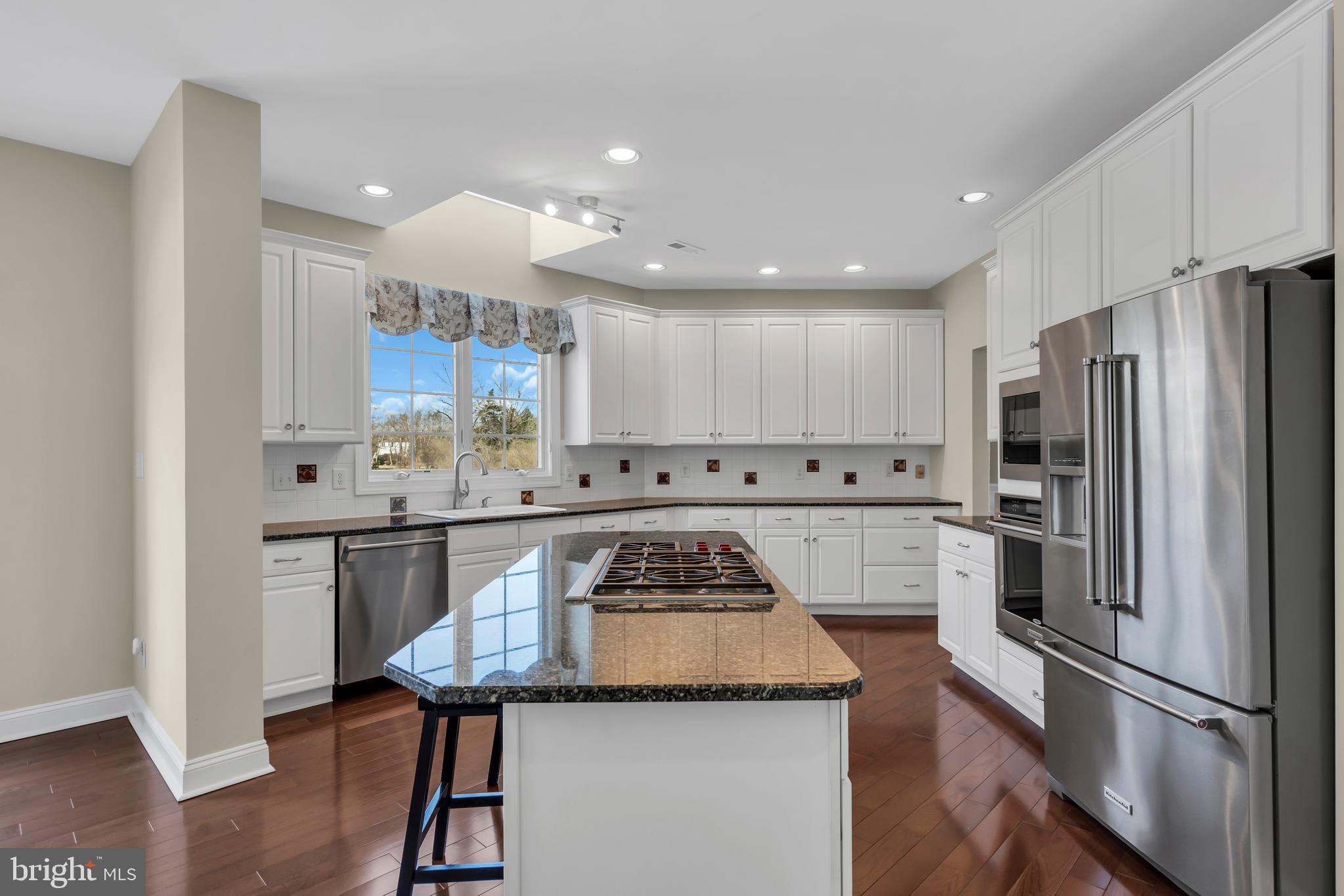 317 Christopher Drive Princeton, NJ 08540 - Photo 20 of 66 a kitchen with stainless steel appliances kitchen island granite countertop a refrigerator and a stove top oven