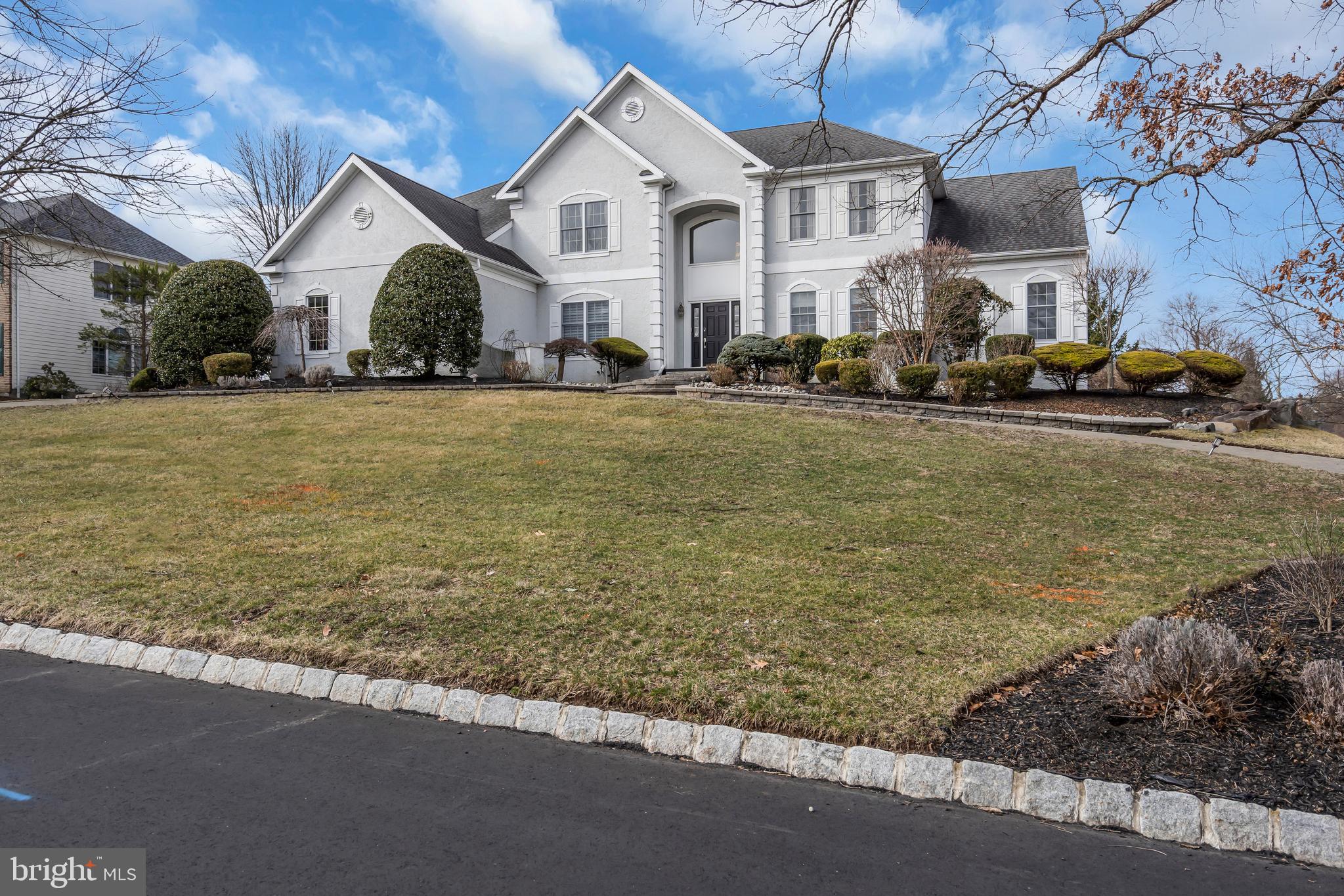 317 Christopher Drive Princeton, NJ 08540 - Photo 4 of 66 a view of a white house with a yard and table and chairs under an umbrella