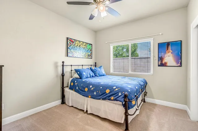 a bed sitting in a bedroom next to a window