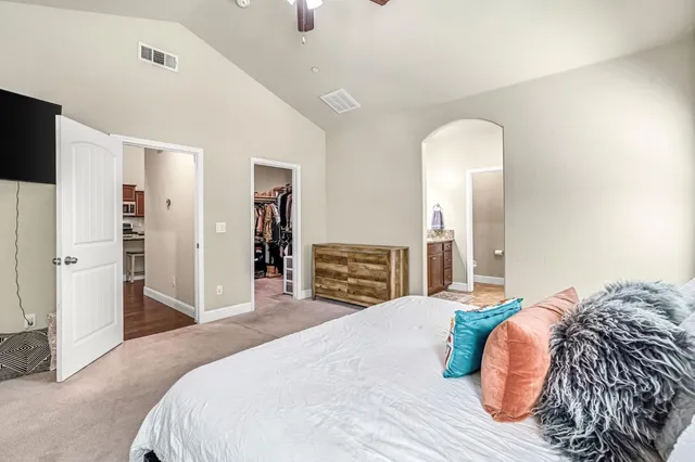 a bedroom with a bed and a television