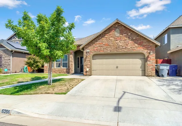 a view of a house with a yard and table and chairs