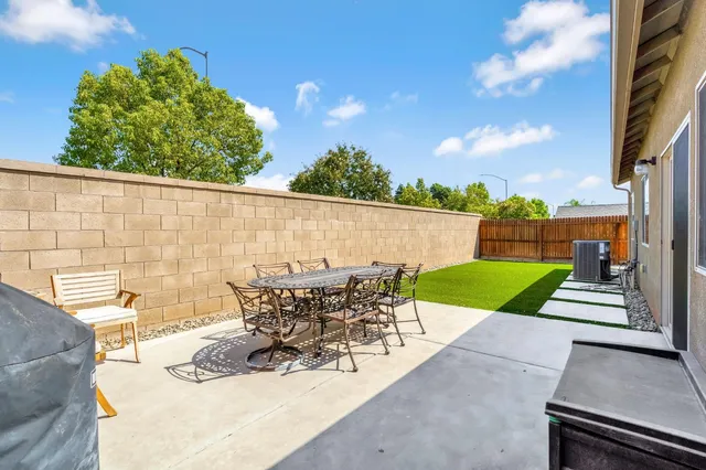 a view of a patio with table and chairs and potted plants