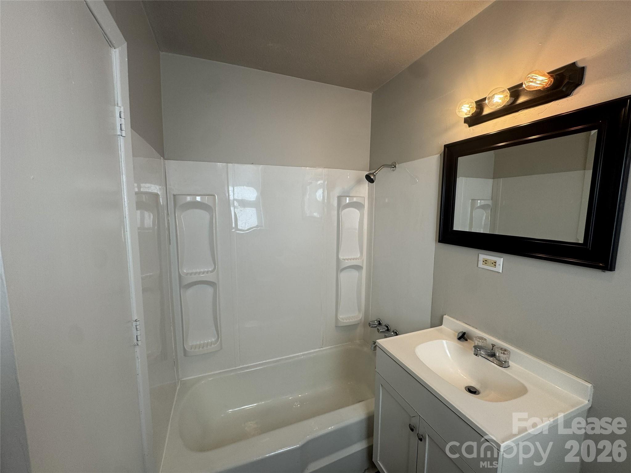 337 Laurel Street Hudson, NC 28638 - Photo 4 of 7 a bathroom with a sink vanity and mirror