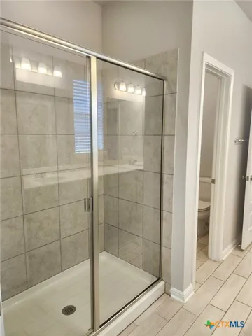a bathroom with a glass shower door