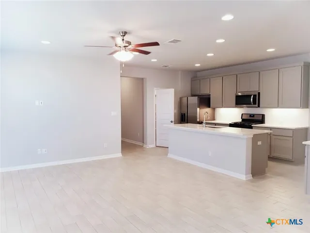 a kitchen with kitchen island microwave and stove