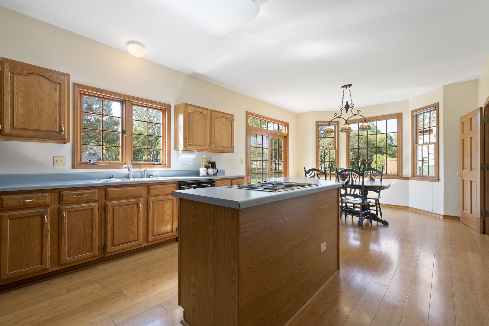 17929 West Pond Ridge Circle Gurnee, IL 60031 - Photo 6 of 28 a open kitchen with stainless steel appliances granite countertop a stove top oven a sink dishwasher a dining table and chairs with wooden floor