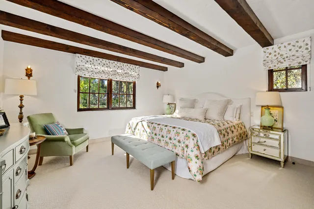 a bed sitting in a bedroom next to a window