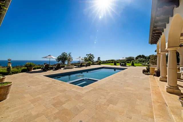 a view of a swimming pool and lounge chairs