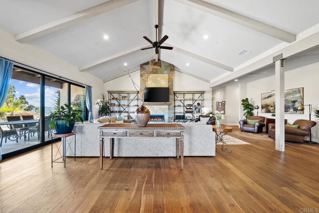 13495 Del Poniente Road Poway, CA 92064 - Photo 13 of 60 a living room with fireplace furniture and a wooden floor