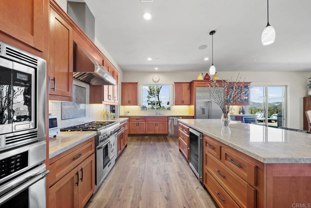 13495 Del Poniente Road Poway, CA 92064 - Photo 16 of 60 a kitchen with stainless steel appliances granite countertop a stove and a sink