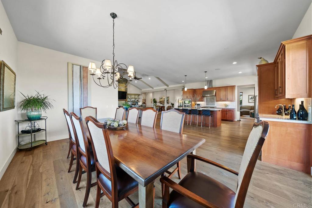 13495 Del Poniente Road Poway, CA 92064 - Photo 17 of 60 a dining room with furniture a chandelier and wooden floor