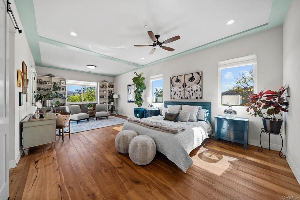 13495 Del Poniente Road Poway, CA 92064 - Photo 23 of 60 a bedroom with a bed and wooden floor
