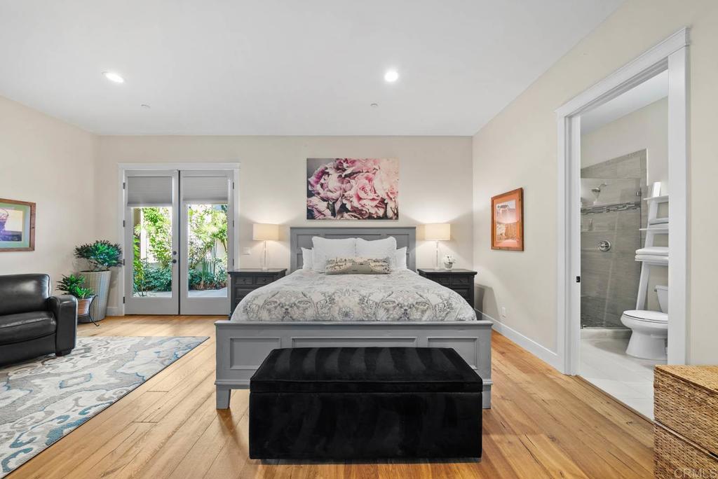 13495 Del Poniente Road Poway, CA 92064 - Photo 31 of 60 a spacious bedroom with a large bed and a wooden floor