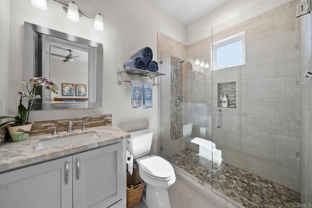 13495 Del Poniente Road Poway, CA 92064 - Photo 35 of 60 a bathroom with a granite countertop toilet sink and shower
