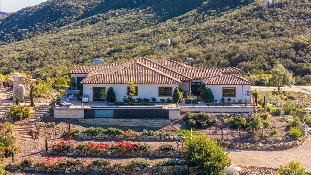 13495 Del Poniente Road Poway, CA 92064 - Photo 54 of 60 a front view of a house with a garden