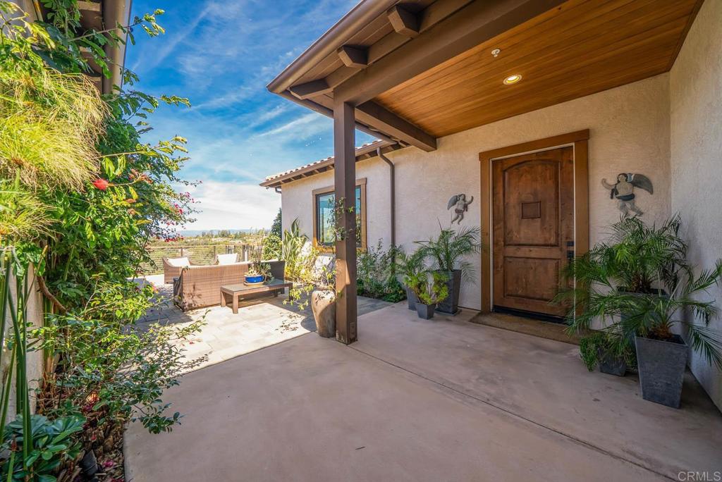 13495 Del Poniente Road Poway, CA 92064 - Photo 10 of 60 a view of a patio with table and chairs and potted plants
