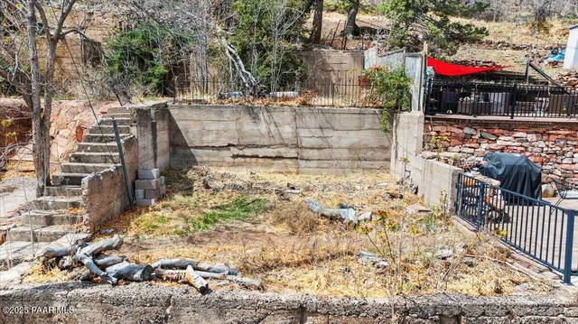 a view of building with wooden stairs and bench