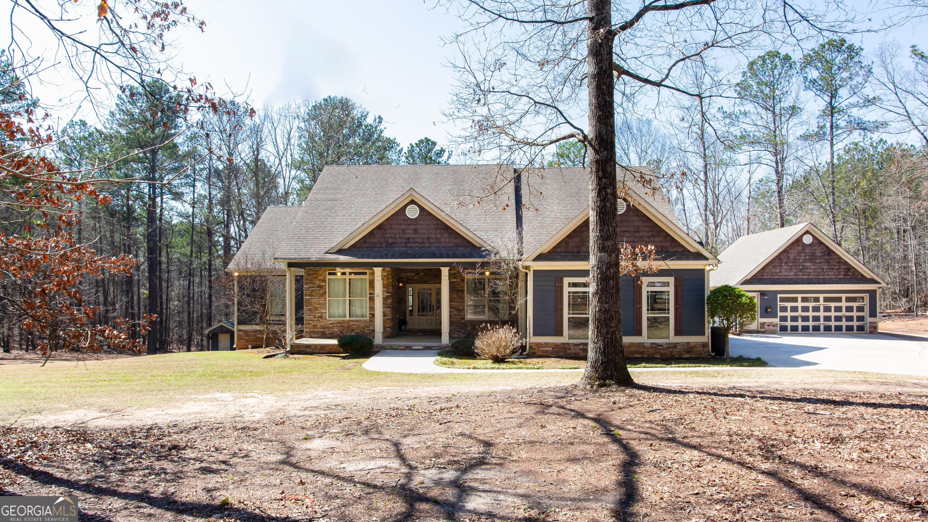 a front view of a house with a yard covered in snow
