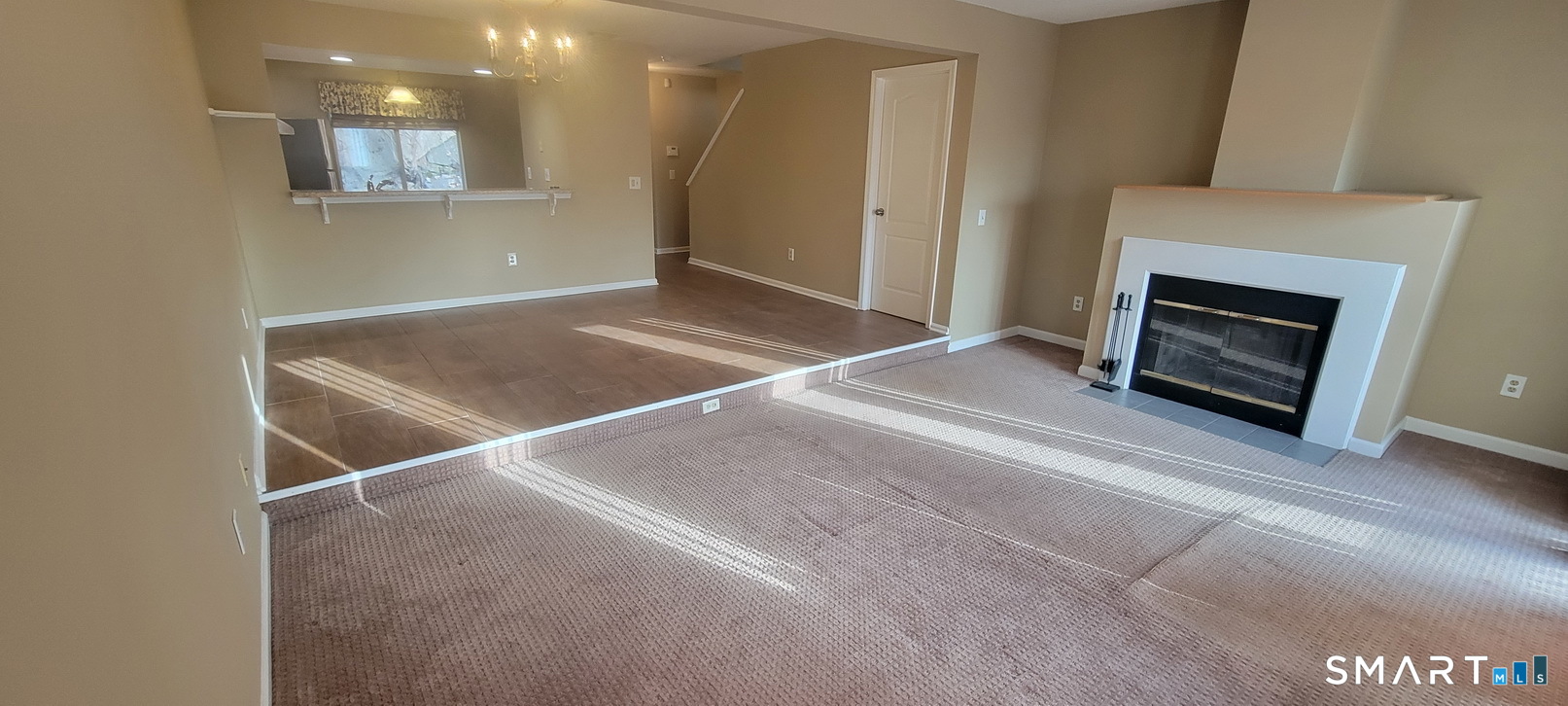 166 Old Brookfield Road, Unit 314 Danbury, CT 06811 - Photo 14 of 37 a view of an empty room with a fireplace and a window
