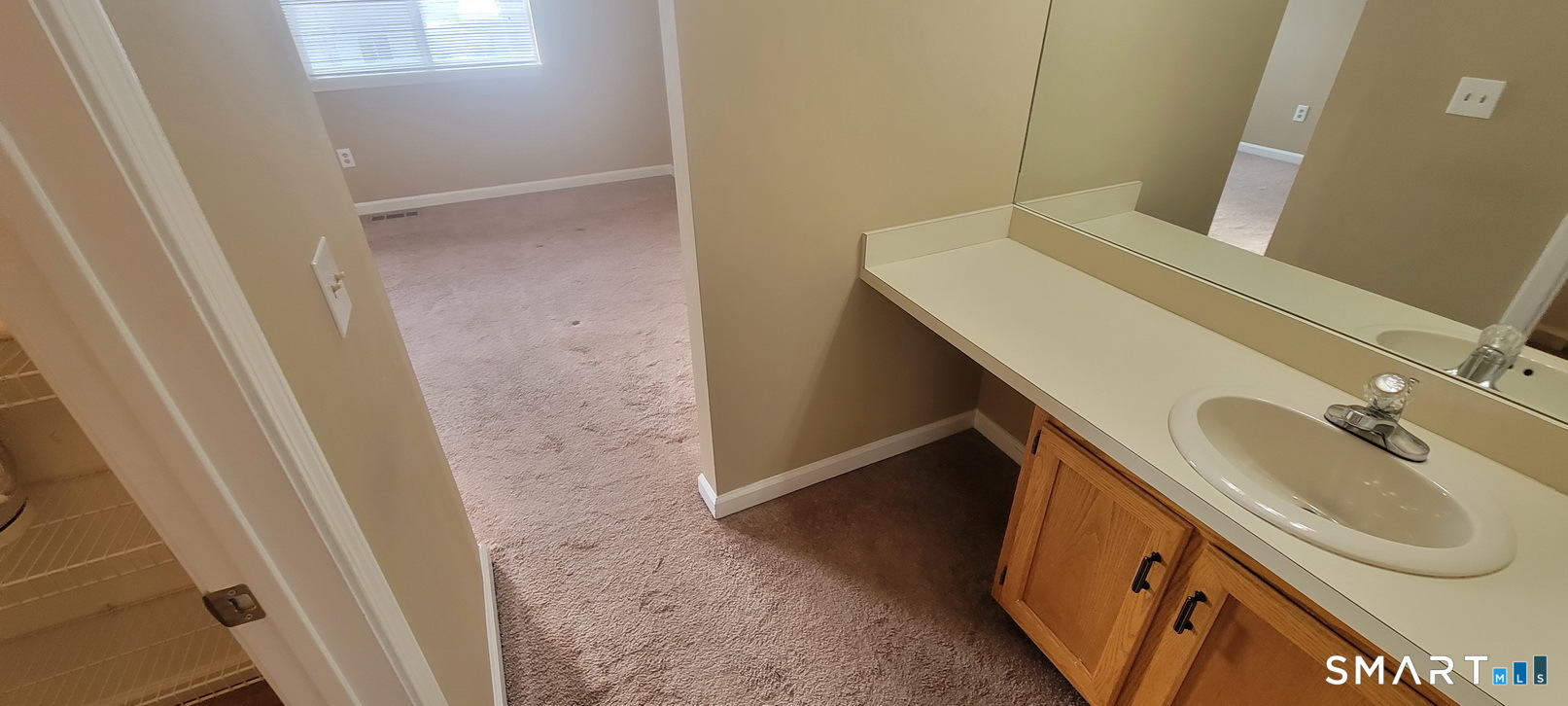166 Old Brookfield Road, Unit 314 Danbury, CT 06811 - Photo 24 of 37 a bathroom with a sink a toilet and a mirror