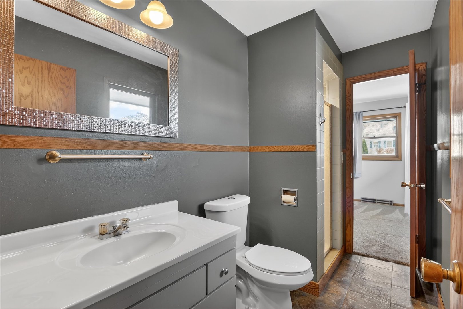 5103 Brookview Road Rockford, IL 61107 - Photo 16 of 51 a bathroom with a sink a toilet and shower