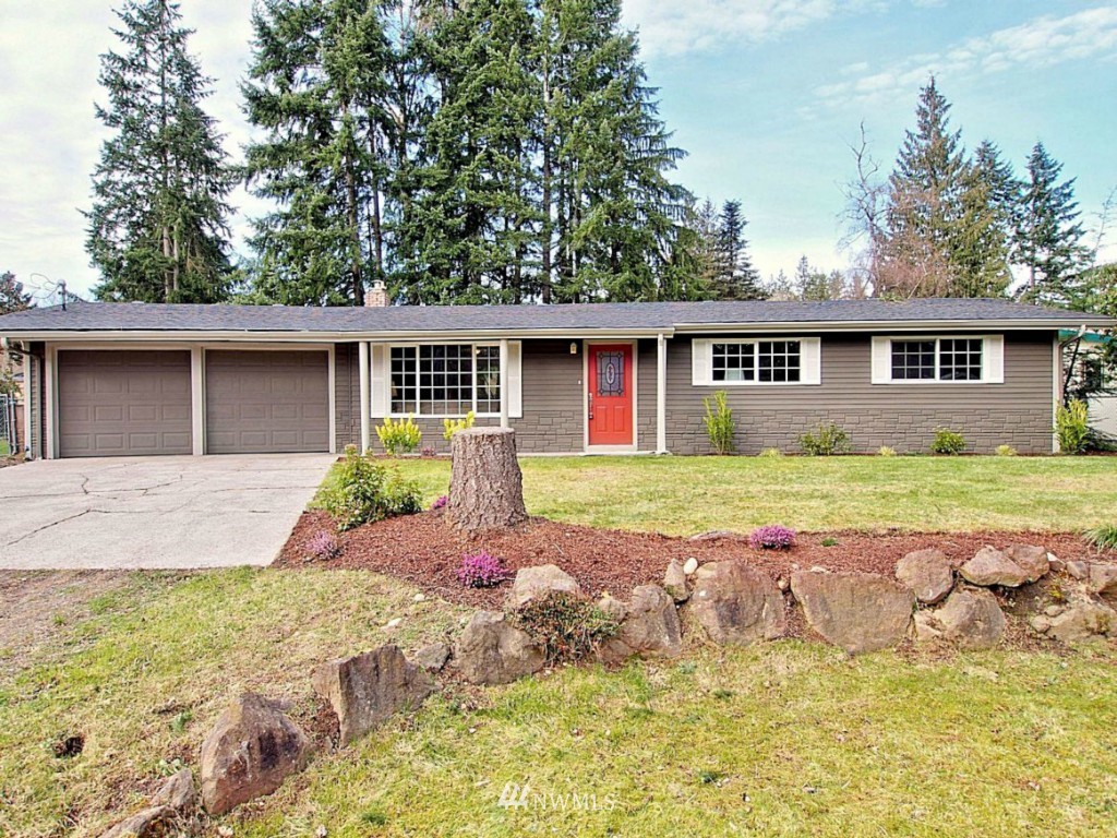 18430 Southeast 135th Street Renton, WA 98059 - Photo 1 of 13 a front view of house with yard and green space