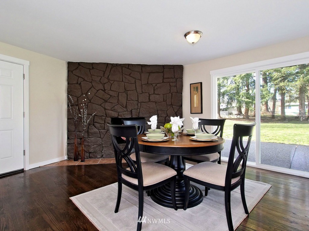 18430 Southeast 135th Street Renton, WA 98059 - Photo 3 of 13 a view of a dining room with furniture and wooden floor