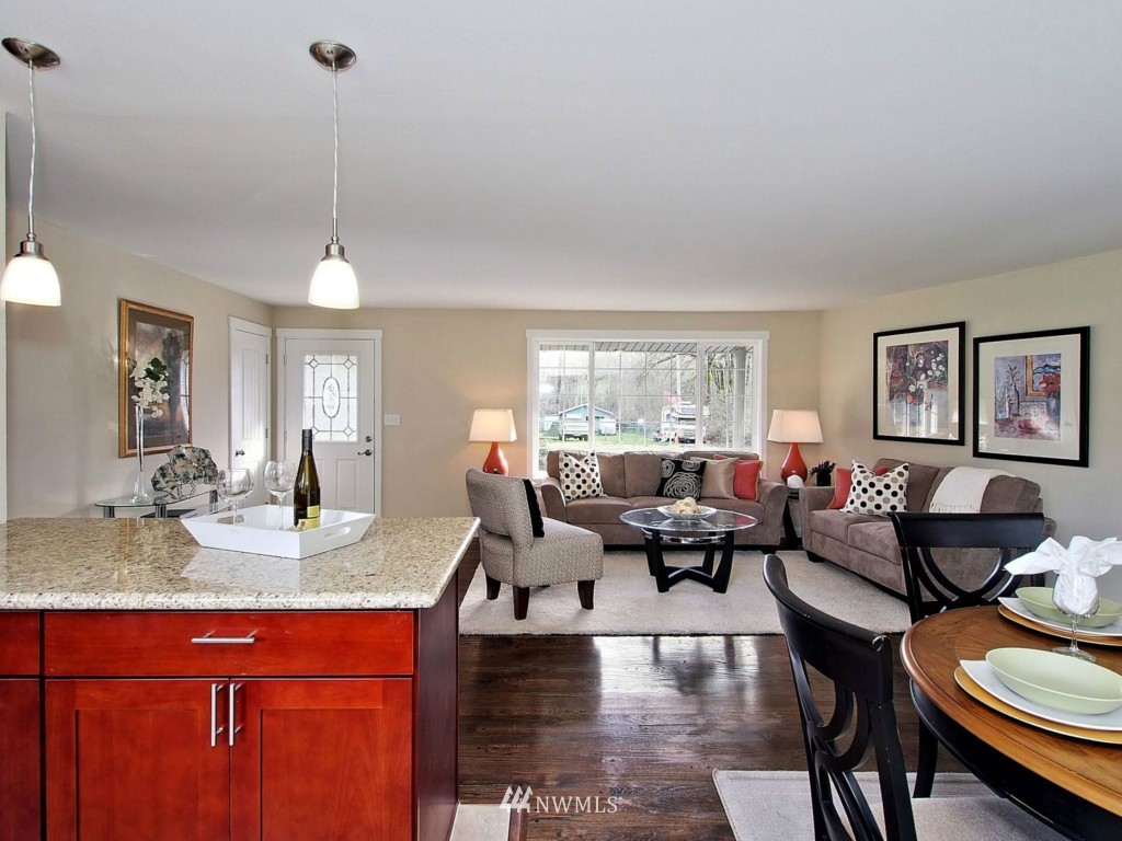 18430 Southeast 135th Street Renton, WA 98059 - Photo 6 of 13 a living room with furniture and a chandelier