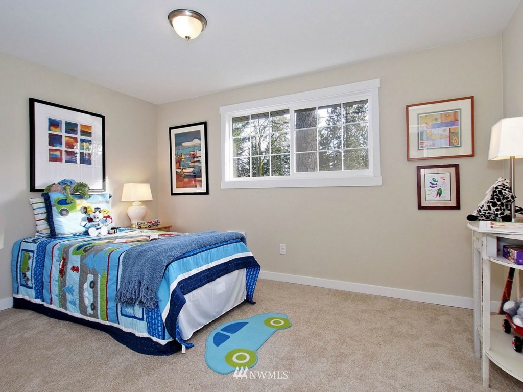18430 Southeast 135th Street Renton, WA 98059 - Photo 7 of 13 a bedroom with a bed and a window