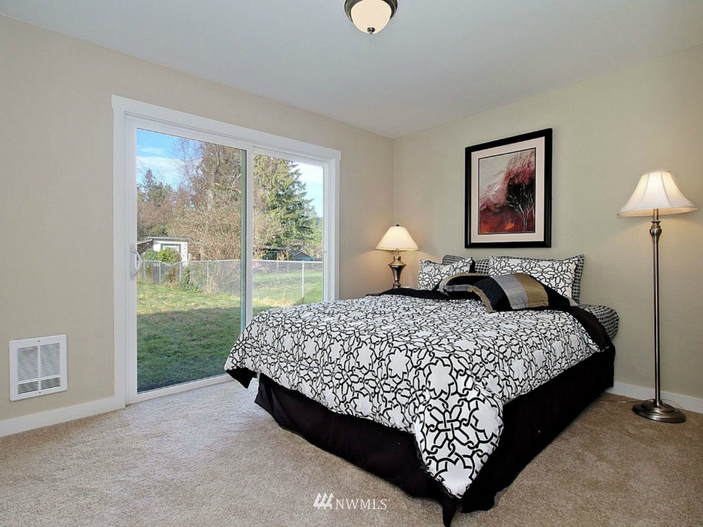 18430 Southeast 135th Street Renton, WA 98059 - Photo 10 of 13 a bed sitting in a bedroom next to a window