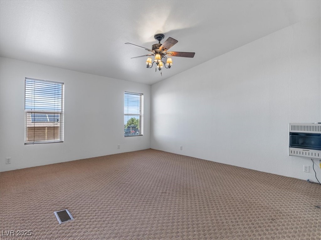 70 West Bonanza Road Las Vegas, NV 89124 - Photo 25 of 71 Carpeted spare room featuring heating unit and a ceiling fan
