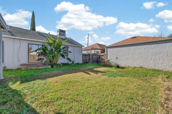 a view of a house with a yard and table and chairs