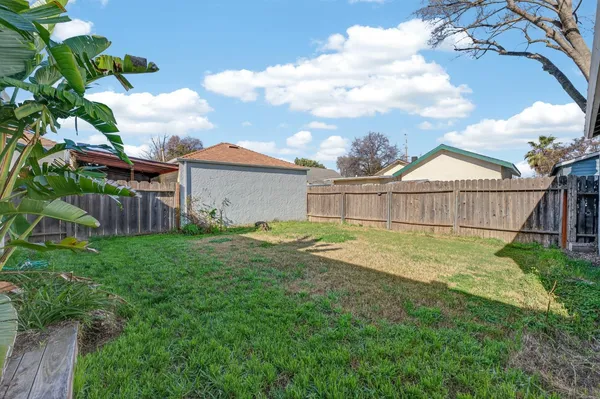 a view of a house with a yard and sitting area