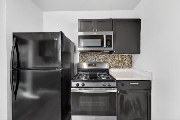 a kitchen with a stainless steel stove and refrigerator