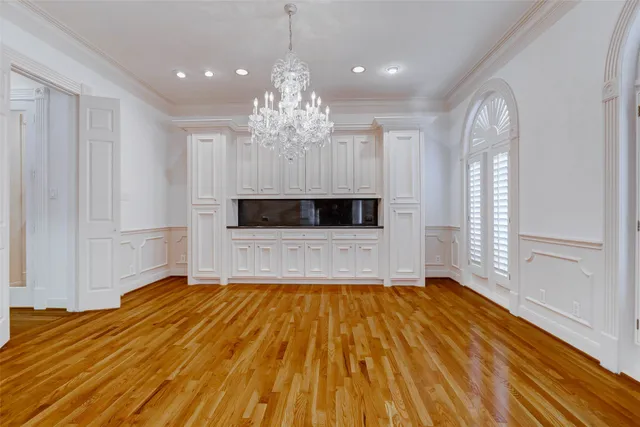 a view of empty room with a wooden floor and windows