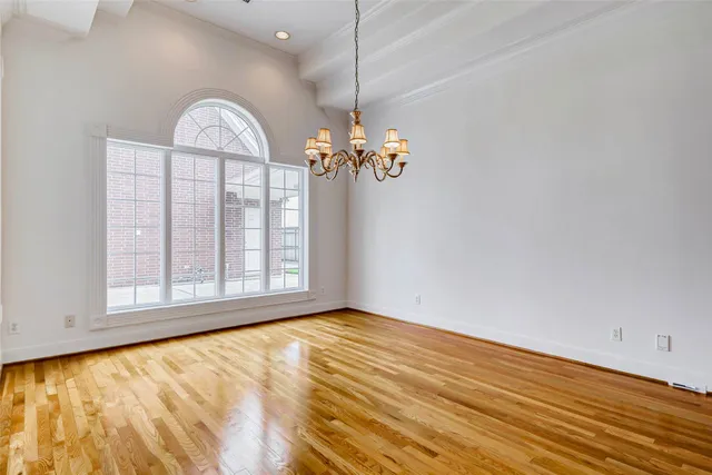 a spacious bathroom with a granite countertop sink a mirror a bathtub and shower