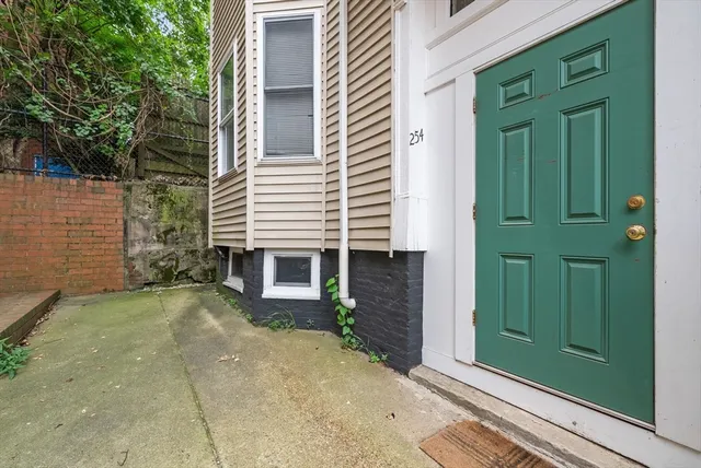 a view of a house with a door and wooden walls
