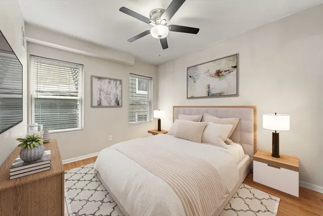 a bedroom with a large bed and a window