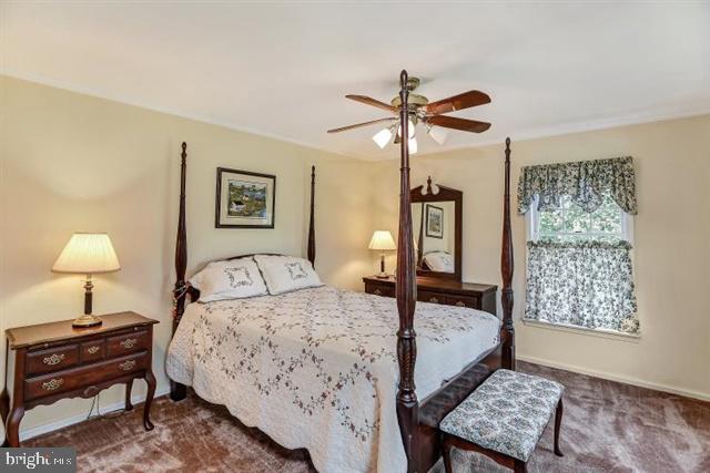 596 Province Line Road Allentown, NJ 08501 - Photo 23 of 50 a bedroom with a bed a chandelier and a dresser