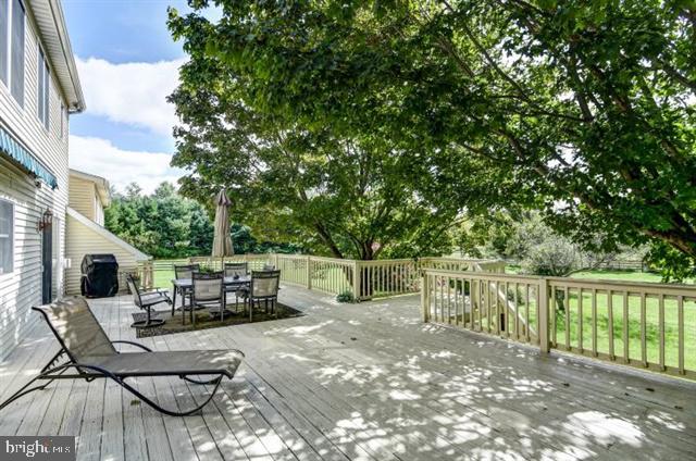 596 Province Line Road Allentown, NJ 08501 - Photo 27 of 50 a view of a patio with table and chairs potted plants with wooden floor and fence