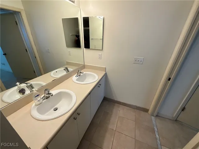 a en suite bathroom with a sink and mirror