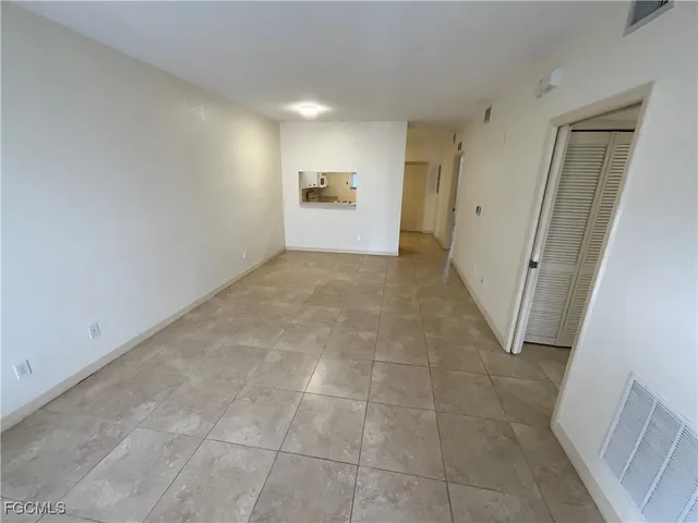 a view of an empty room and fire place