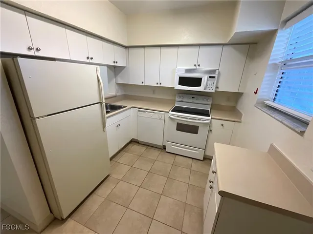 a kitchen with a refrigerator sink and microwave