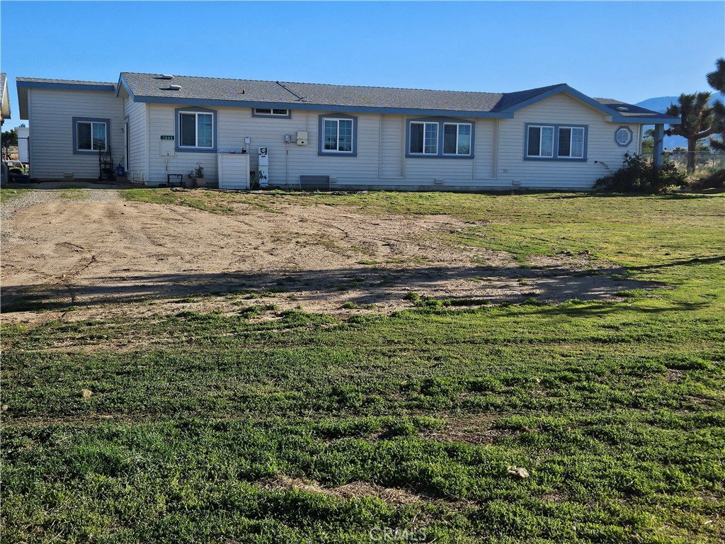 7063 Nielson Road Phelan, CA 92371 - Photo 1 of 1 a front view of a house with a yard