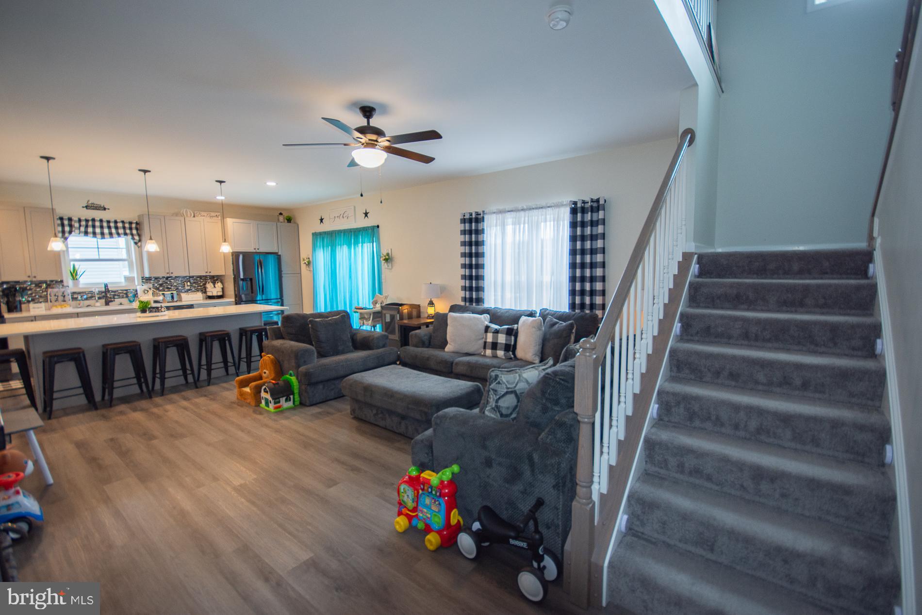 90 Larimar Lane Inwood, WV 25428 - Photo 13 of 66 a living room with furniture and a dining table with wooden floor