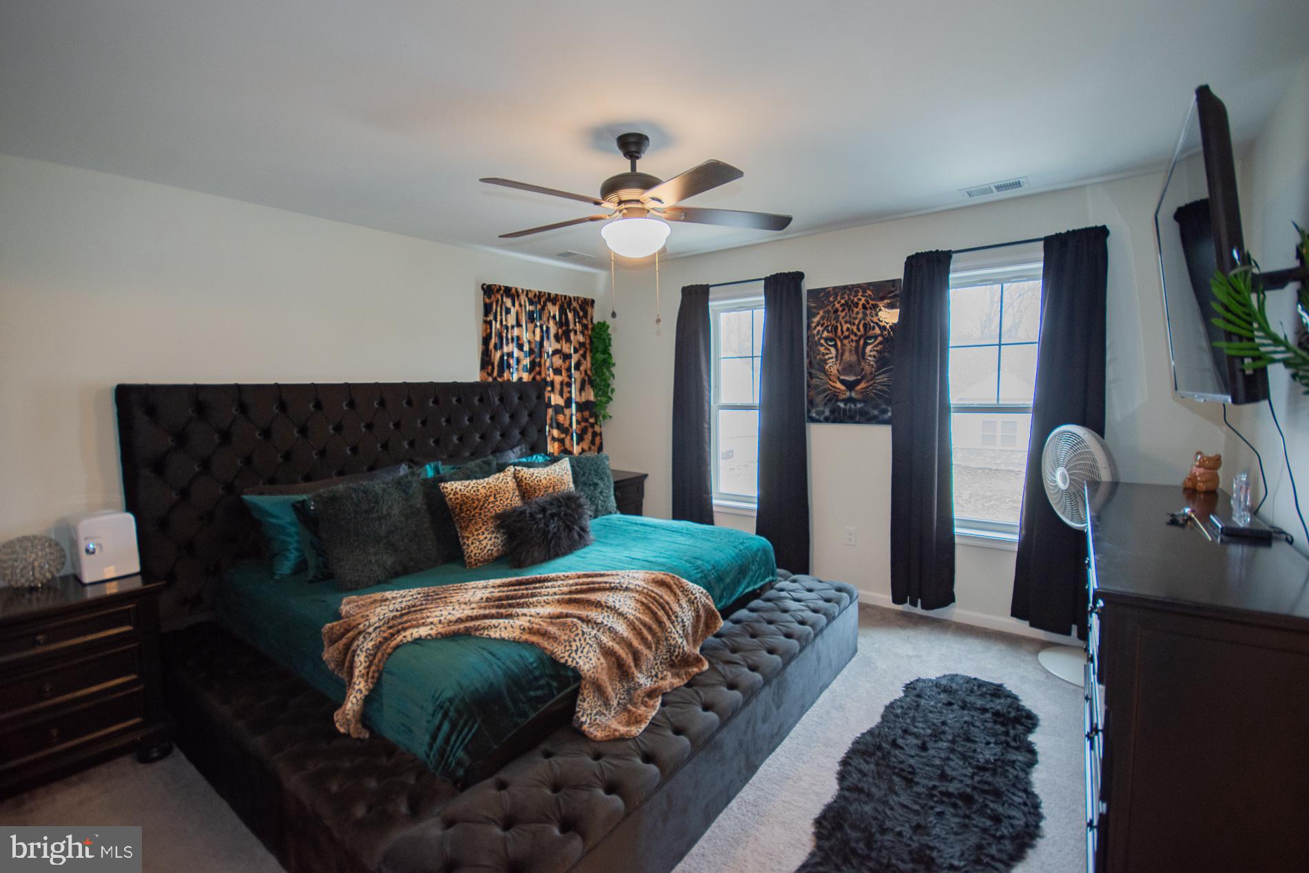 90 Larimar Lane Inwood, WV 25428 - Photo 14 of 66 a bed sitting in a bedroom next to a window with pc on the dresser