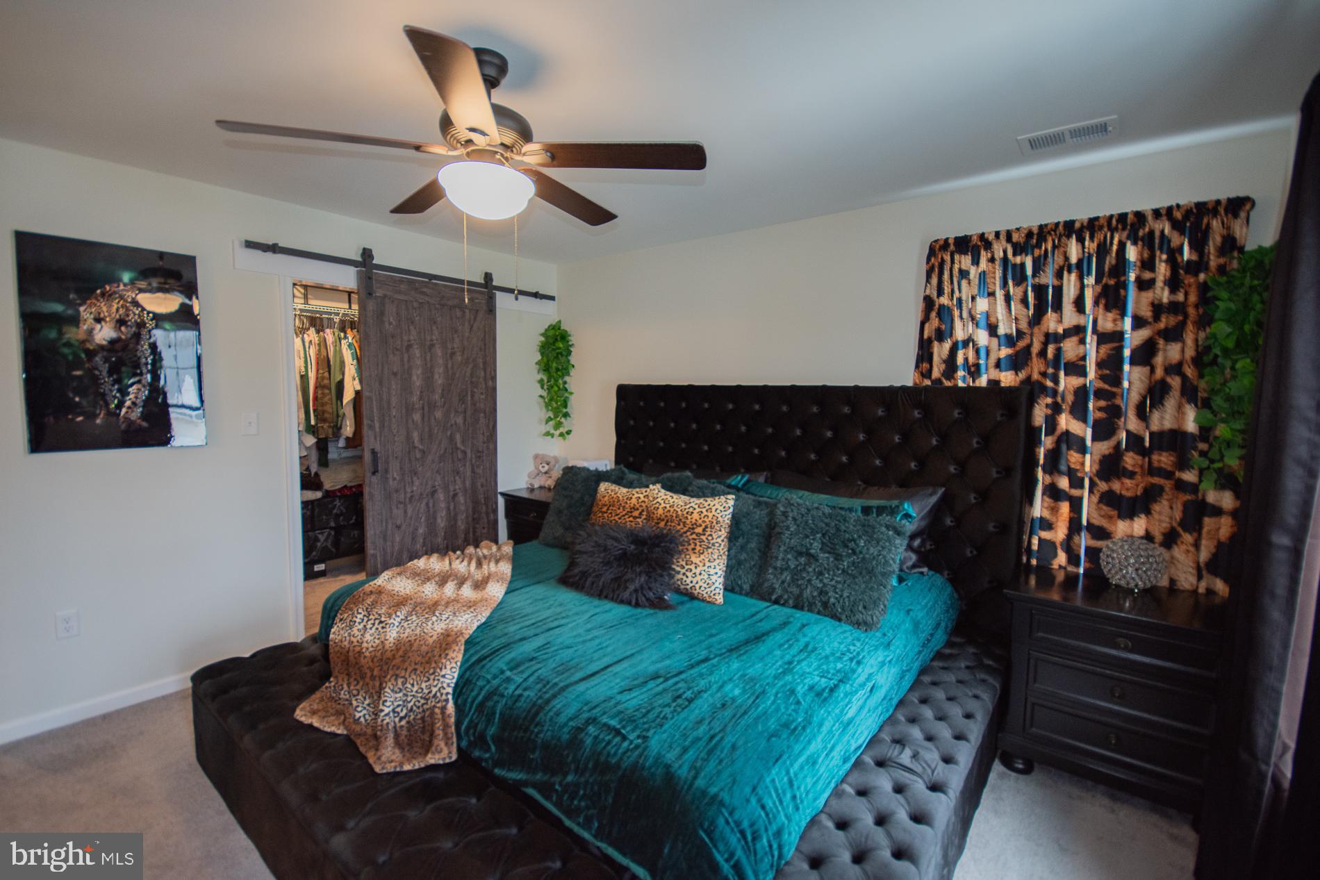 90 Larimar Lane Inwood, WV 25428 - Photo 15 of 66 a bed sitting in a bedroom next to a window