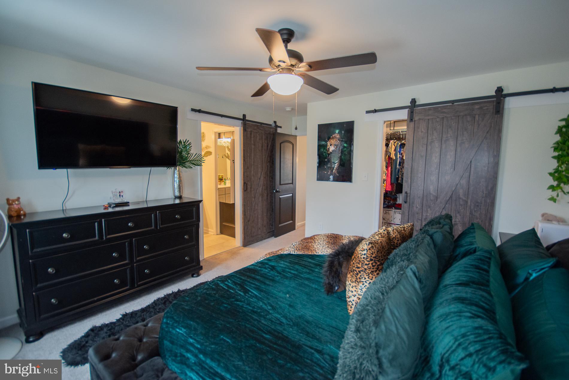 90 Larimar Lane Inwood, WV 25428 - Photo 16 of 66 a spacious bedroom with a bed and a flat screen tv