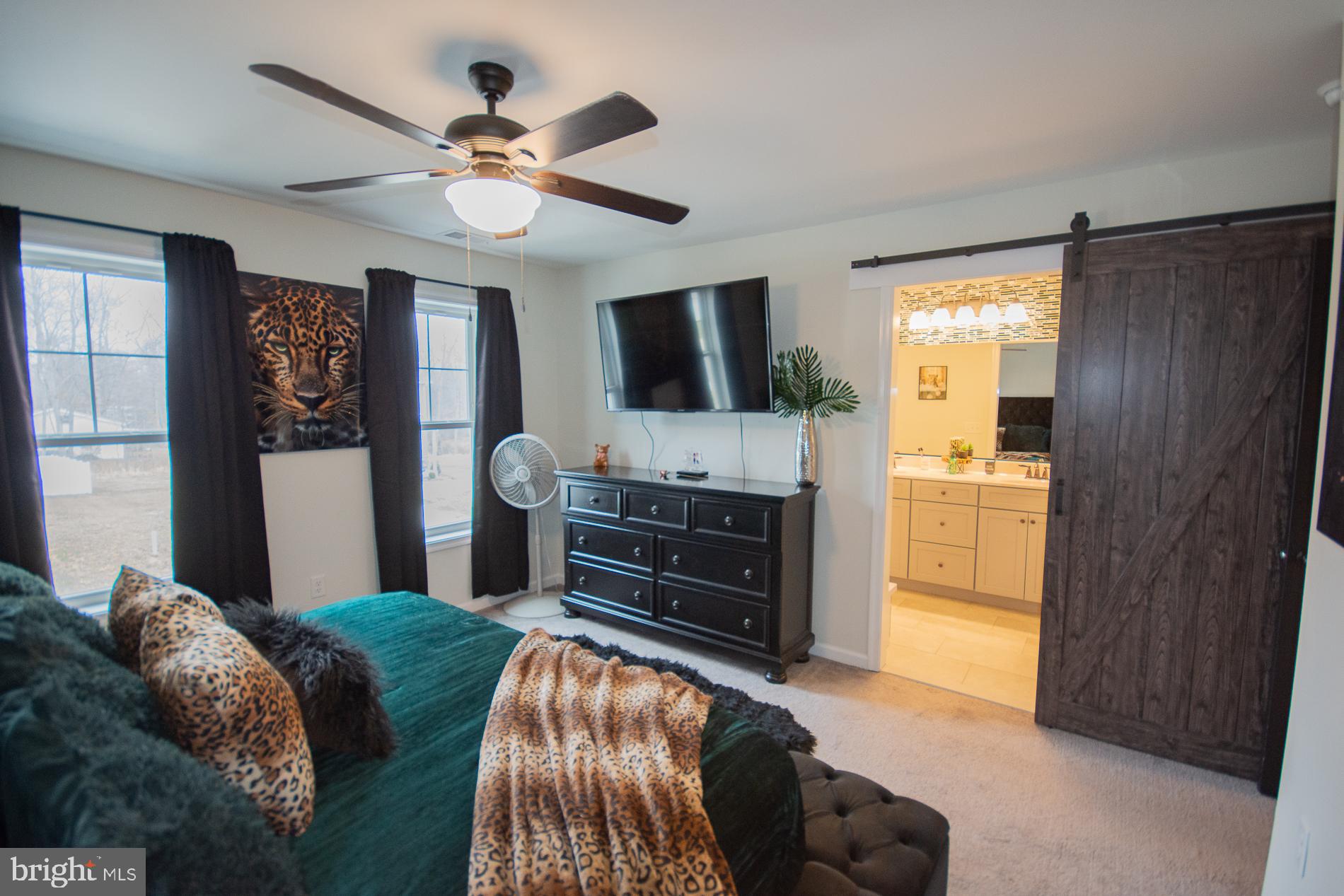 90 Larimar Lane Inwood, WV 25428 - Photo 17 of 66 a bedroom with a bed and a flat screen tv