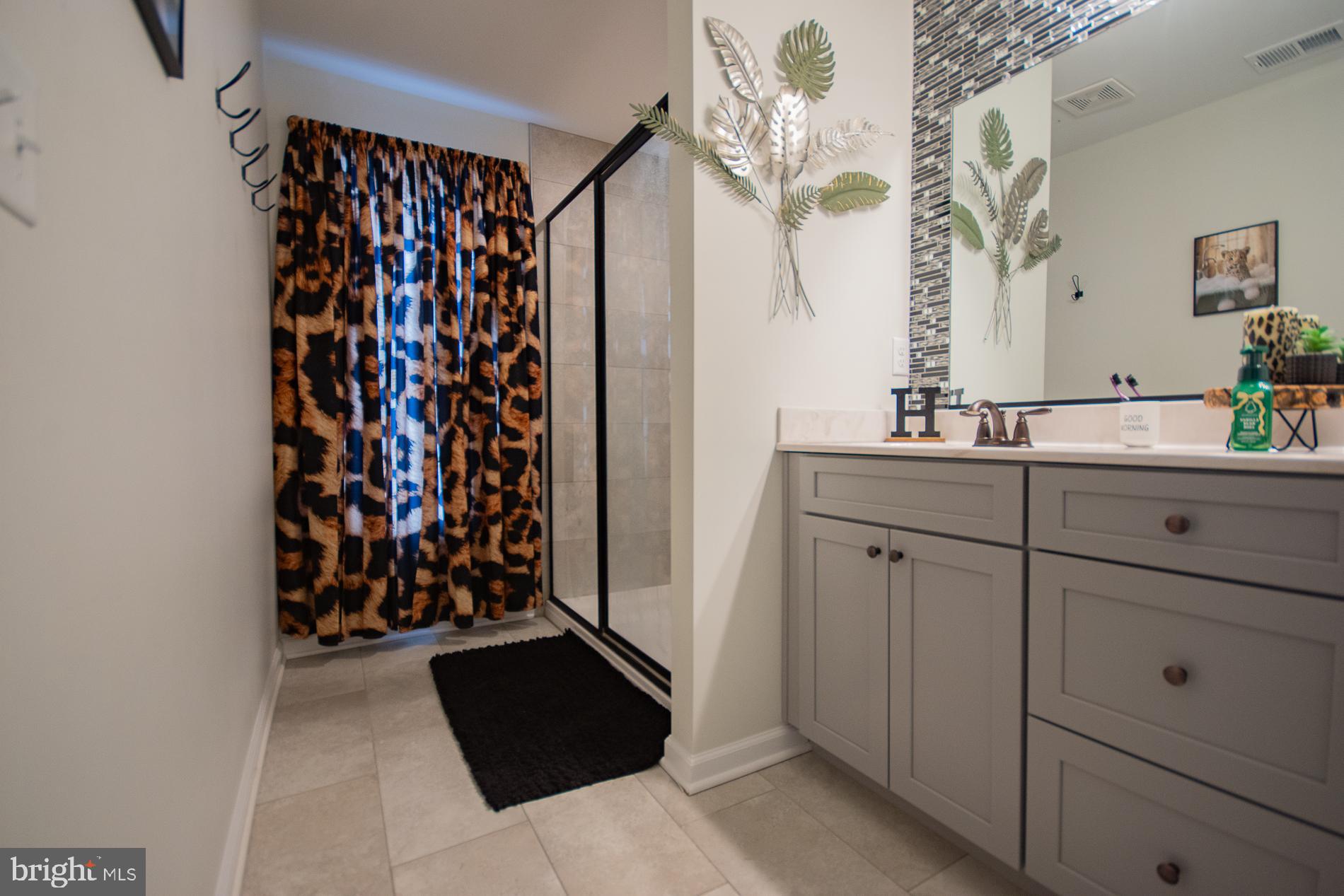 90 Larimar Lane Inwood, WV 25428 - Photo 21 of 66 a view of a bathroom with a double vanity sink and mirror